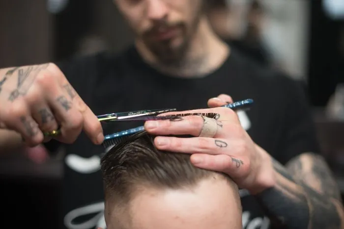 Scissors closing on a section of hair